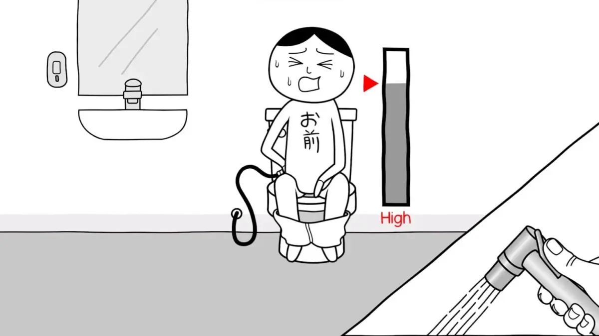 トイレに座りウォシュレットを使用する人物