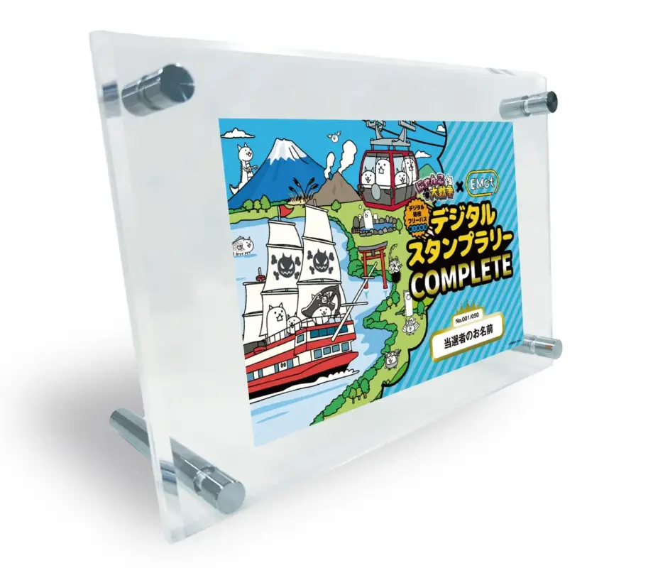 アクリルスタンドに飾られた、人気ゲーム「にゃんこ大戦争」と「Emot」のコラボレーションによるデジタルスタンプラリー「COMPLETE」の記念イラストです。