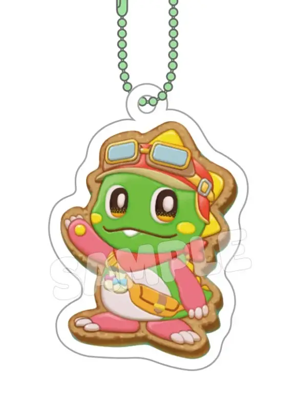 パイロットゴーグルとスカーフを身につけた緑色のカエル型キャラクターのクッキー風アクリルキーホルダーです。