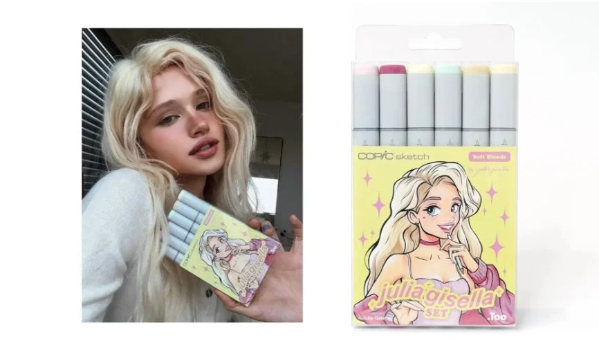 Julia Gisella氏がコピックスケッチマーカーセット「Julia Gisella SET」を持っている画像。セットは柔らかな色合いで、パッケージにはブロンドのキャラクターが描かれている。