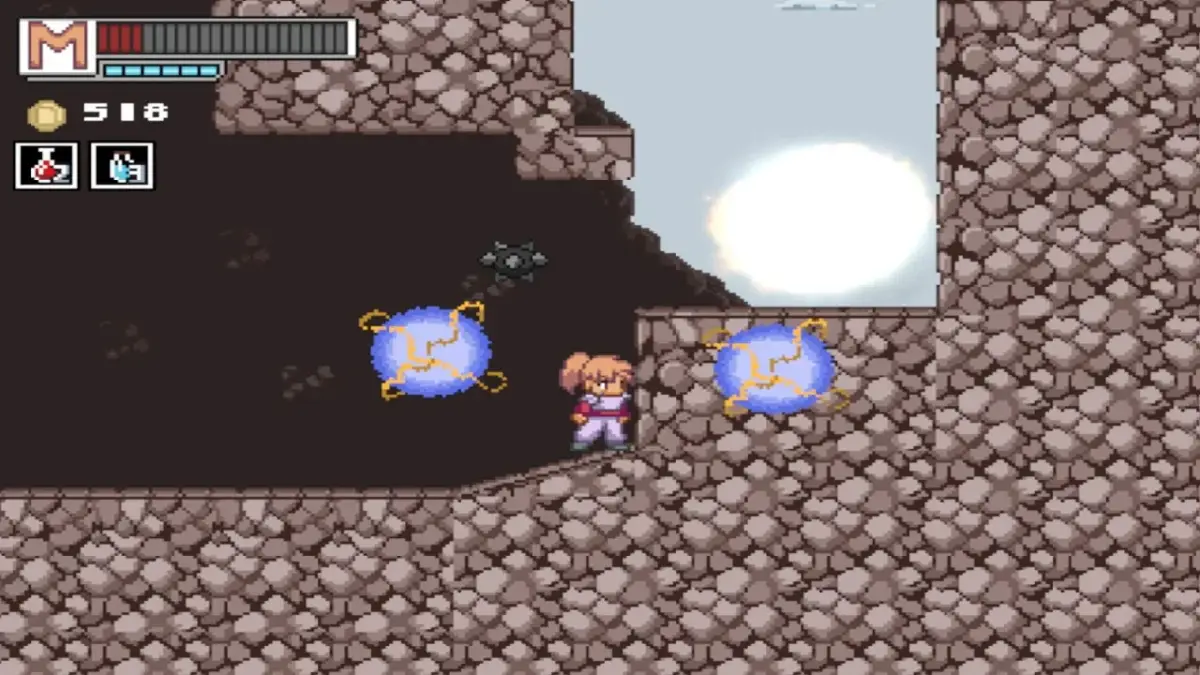 ピクセルアートの2Dアクションゲーム画面。洞窟ステージで、主人公が青い魔法のような球体や飛ぶ敵に囲まれている。