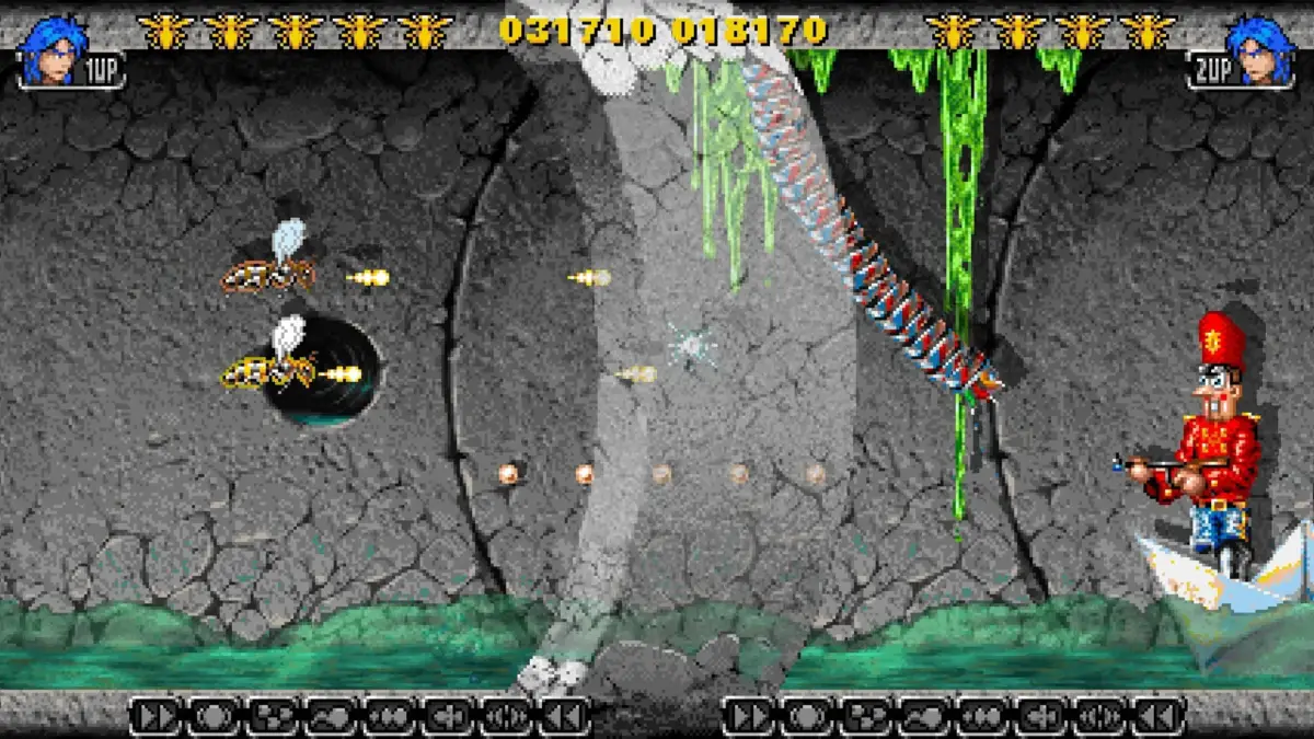 レトロなピクセルアートの横スクロールシューティングゲームのプレイ画面。洞窟のようなステージで、プレイヤーキャラクターが蜂のような敵と交戦中